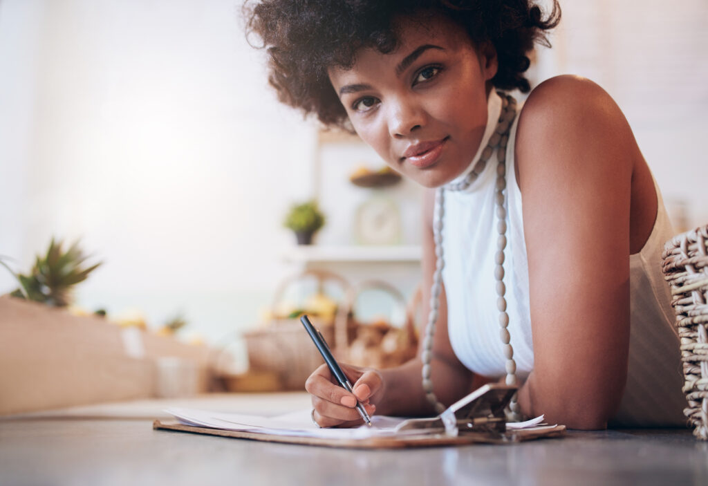 Woman sitting at desk tracking tasks on her corporate event planning checklist