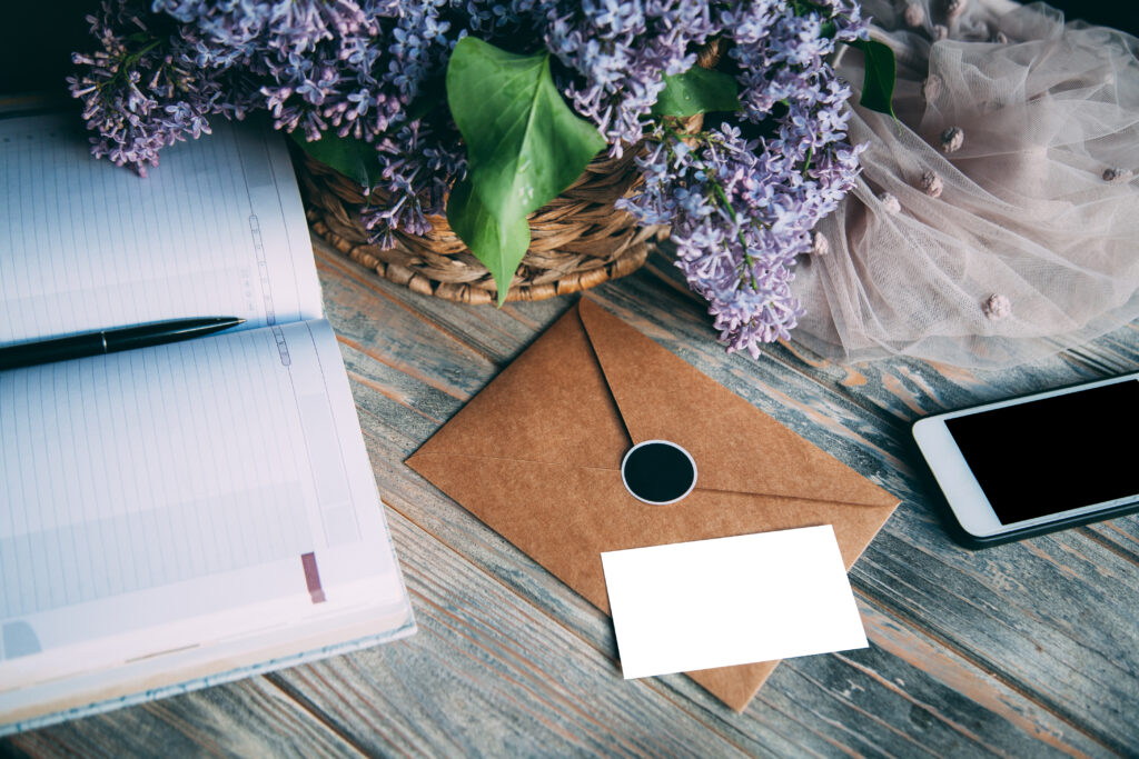 Work desk with notebook and event invitation