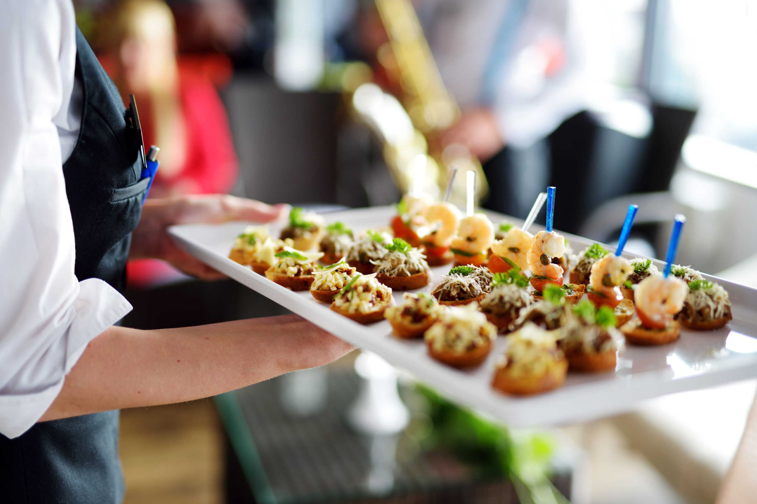 Tray of food being distributed at a corporate event